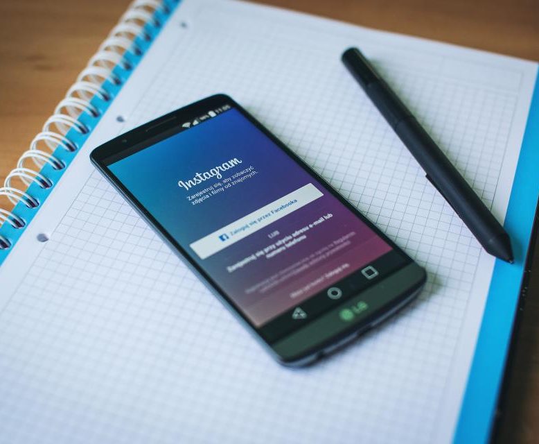 A smartphone showing the Instagram app on a notebook