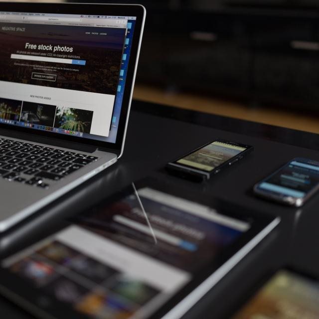 One website shown on a laptop, tablet and phones