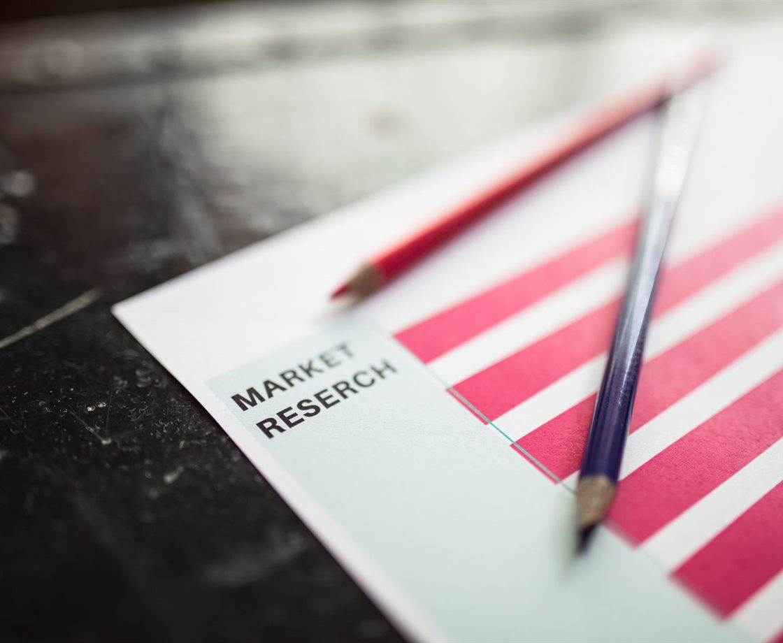 A market research report with bar charts and pencils