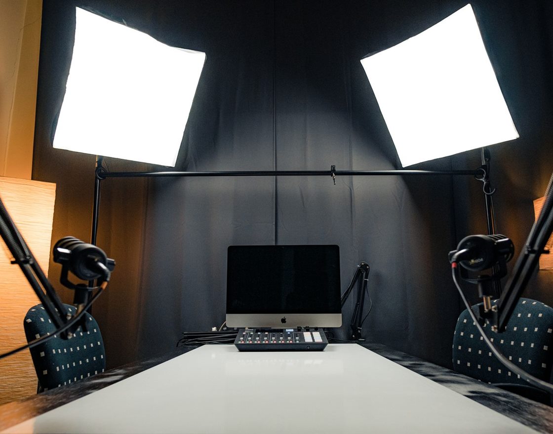 A modern content studio with lights, microphones and a monitor