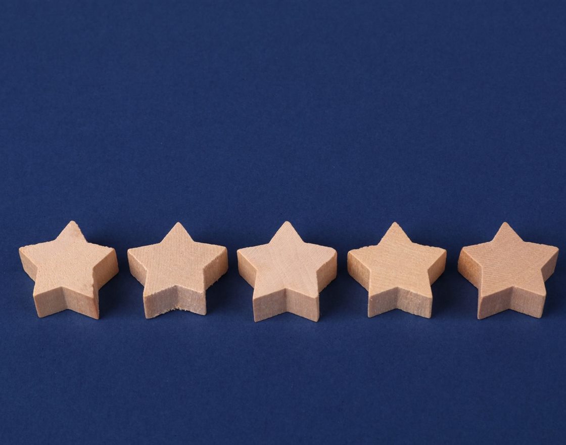 Five wooden stars on a blue background