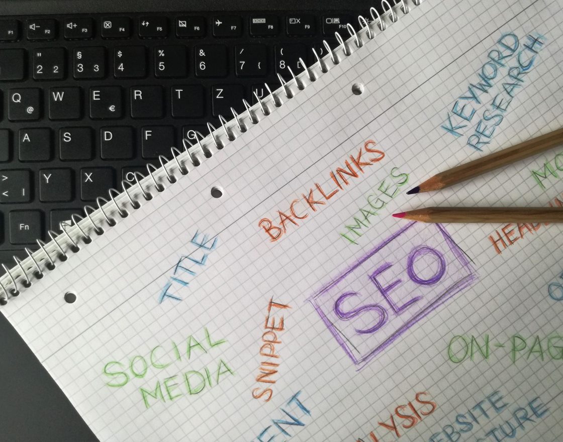 A notebook mapping SEO terms: keywords, backlinks, titles and on-page