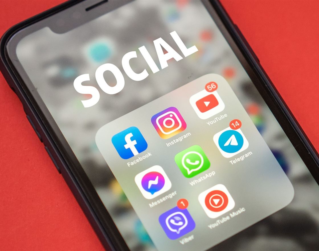 A smartphone with a folder of social media apps